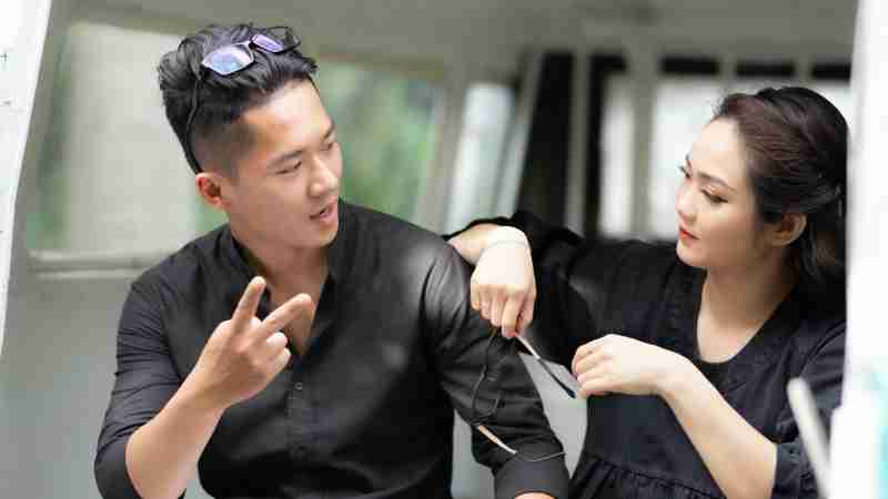 Asian couple talking and smiling indoors, highlighting connection and interaction., tags: terapia di la della comunicazione - pexel